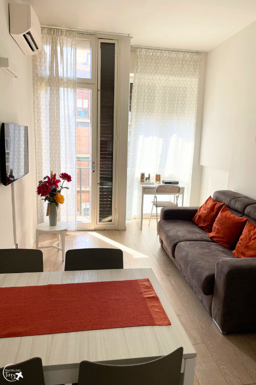 dining table and gray couch in a room in a living room in Santa Croce neighborhood in Florence