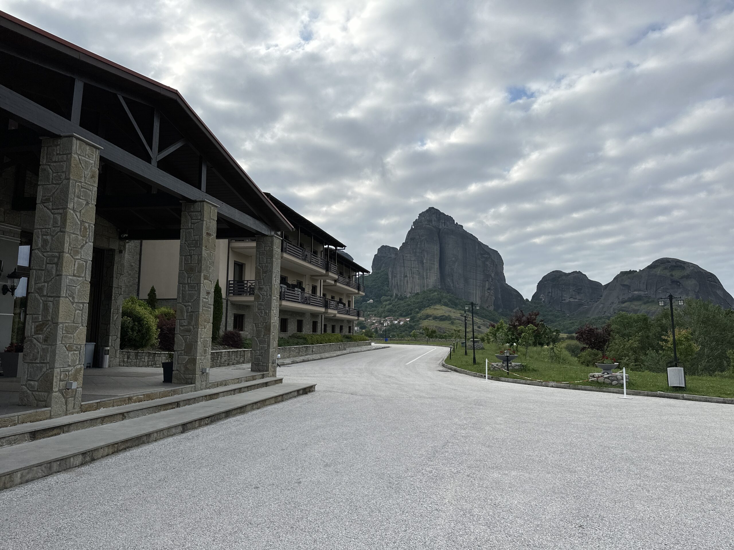 view of the Grand Meteora hotel with the cliffs in the background