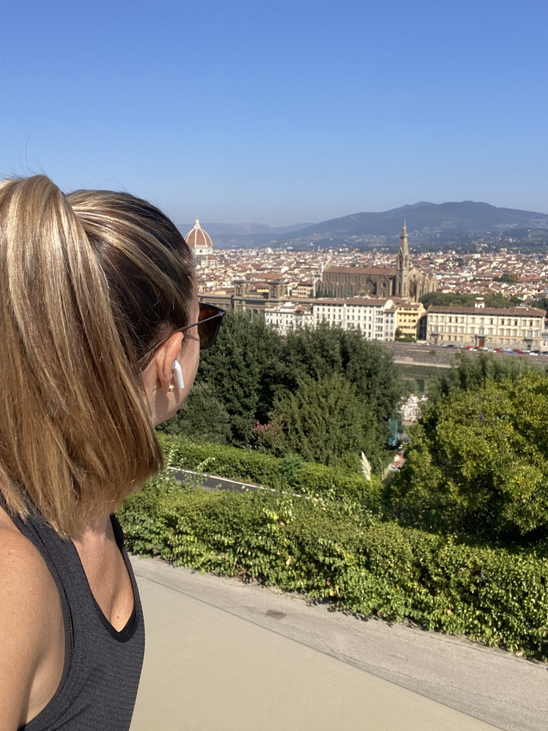a woman looks out at the view of Florence from Piazzale Michelangel