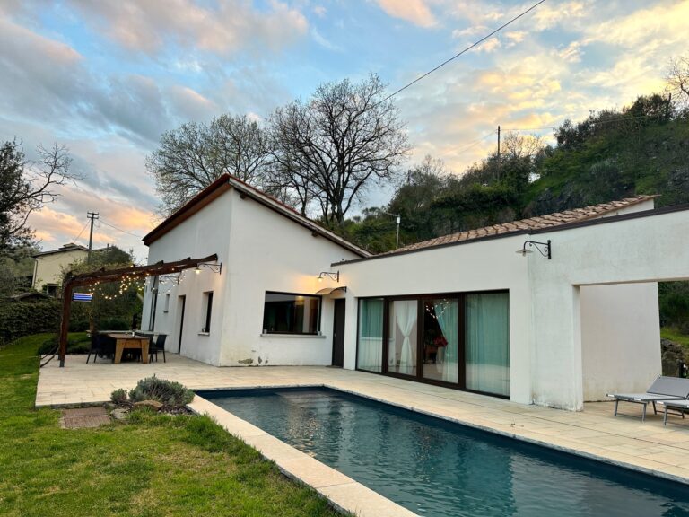 Tuscan farmhouse exterior with a pool, captured at sunset, offering a tranquil retreat near Florence.