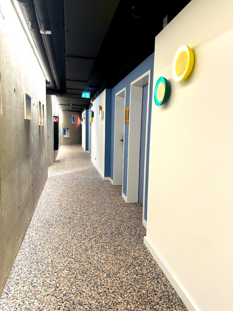 Villa Viva Hamburg 1 Colorful and modern hallway design at Villa Viva Hotel in Hamburg showcasing unique lighting and vibrant decor elements.