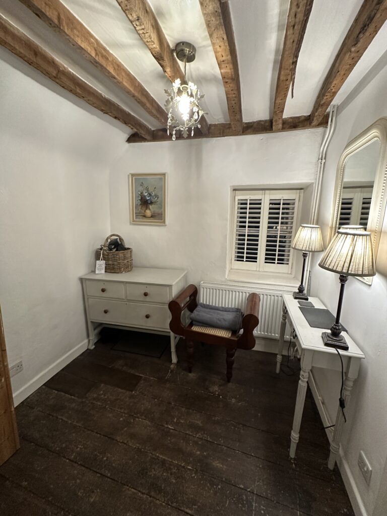 Chalford Cottage Cotswolds 12 Bright and rustic workspace at Minnow Cottage in the Cotswolds, featuring vintage furniture, wooden beams, and soft ambient lighting for a cozy work environment.