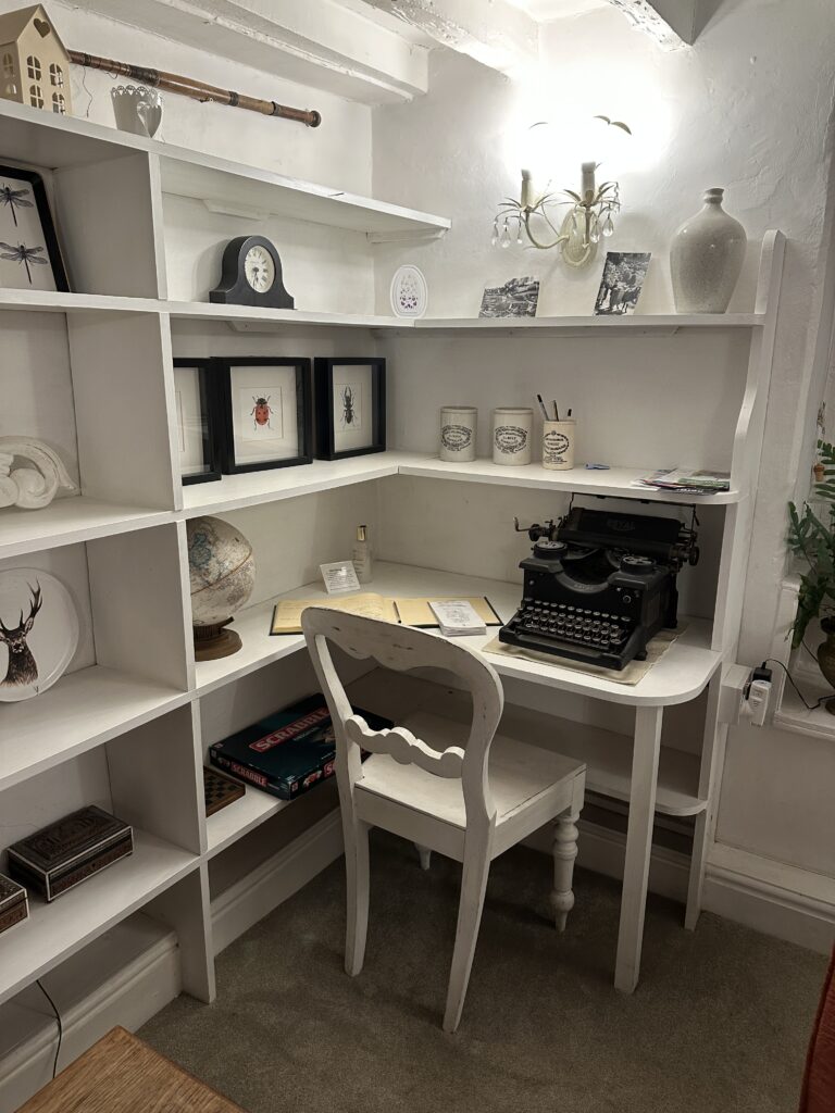 Chalford Cottage Cotswolds 18 Bright and cozy writing nook at Minnow Cottage with antique furniture and soft lighting, perfect for a peaceful workcation in the Cotswolds.
